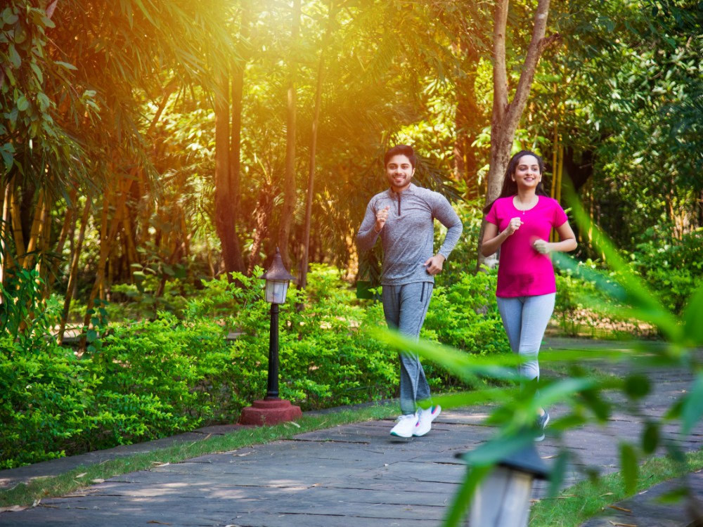 indian asian young couple jogging running exercising stretching outdoors park nature Embracing a More Intentional Lifestyle